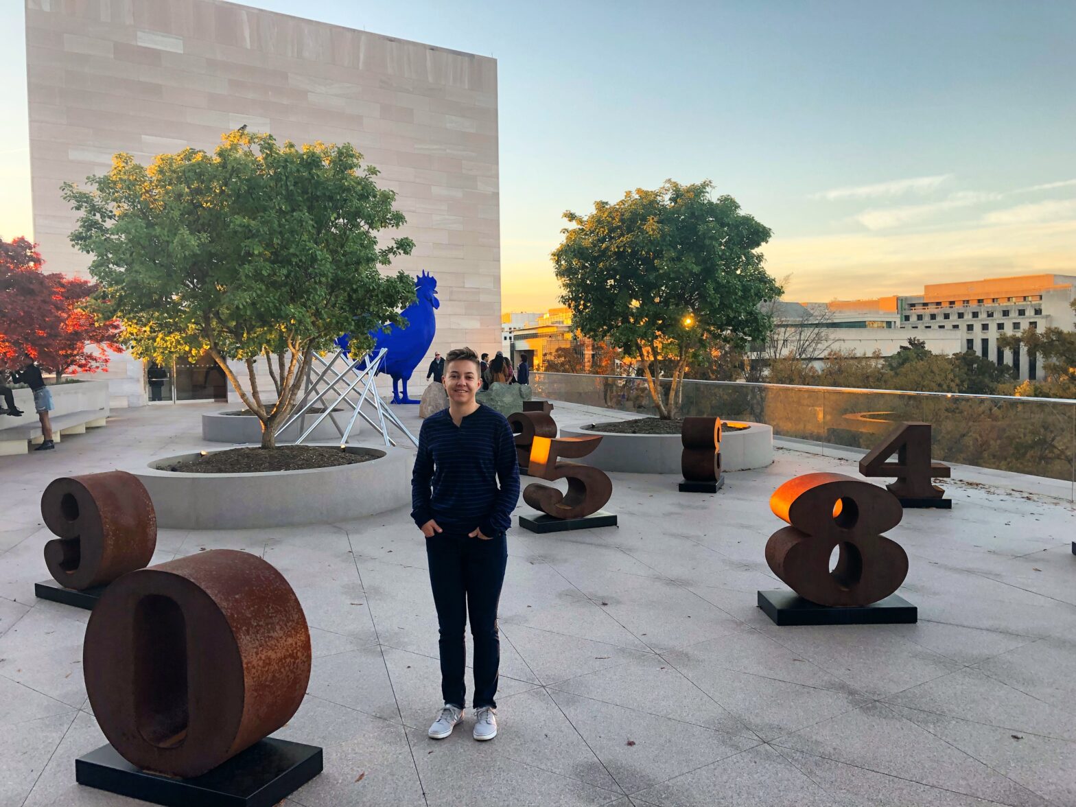 Lindsey stands in front of art on rooftop in DC